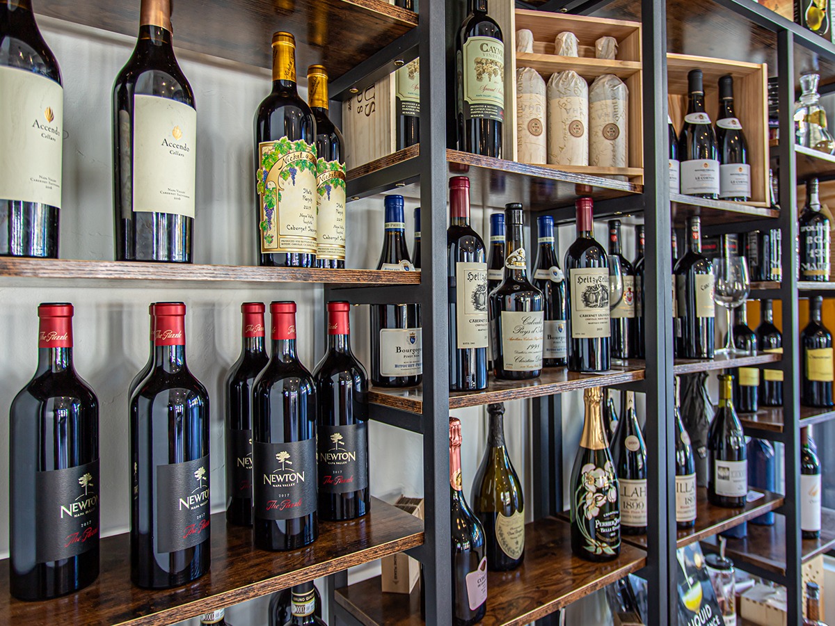 Curated wine shelves inside Wild Plum Spirits