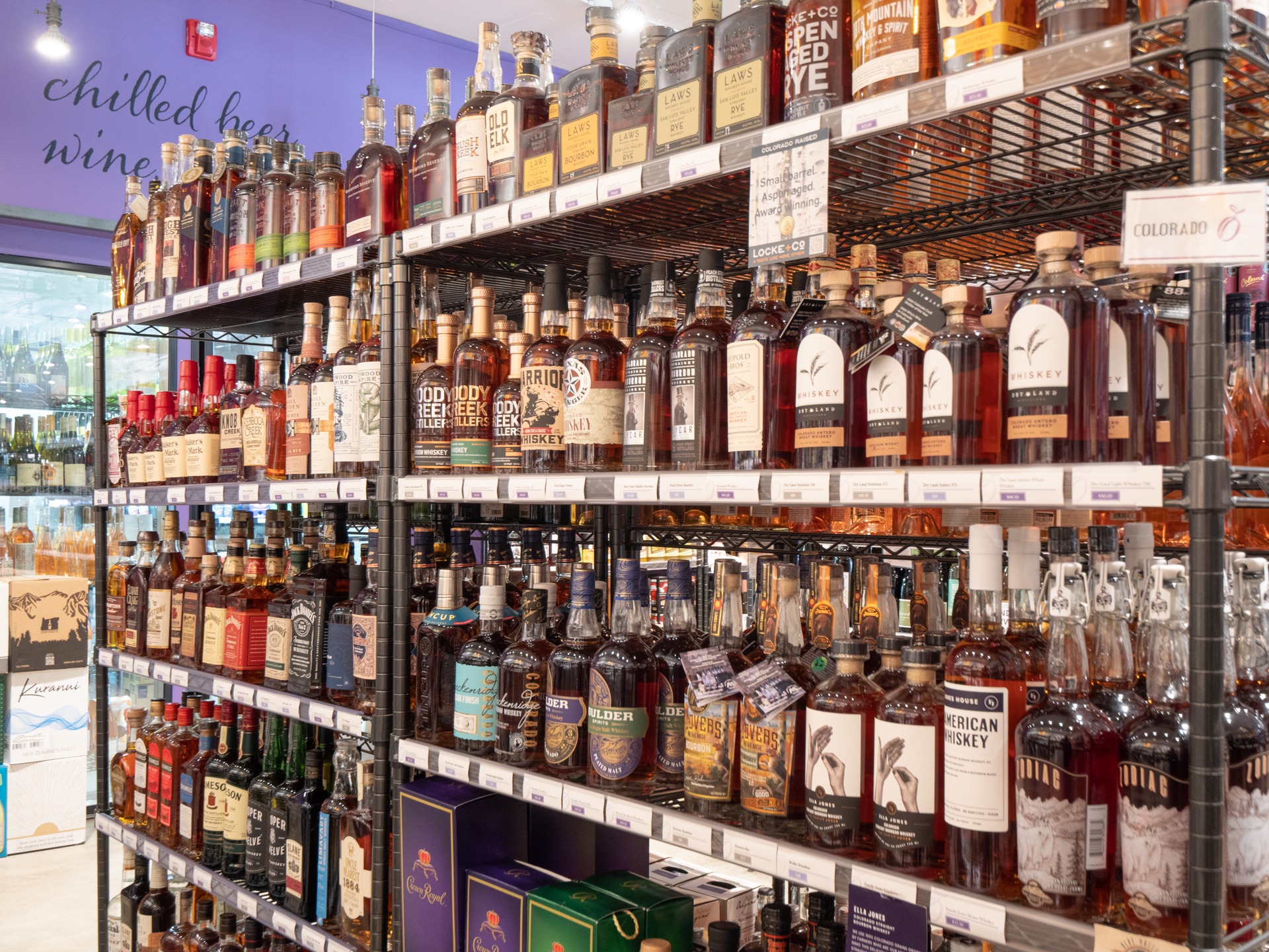 Whiskey and spirits shelves at Wild Plum Spirits